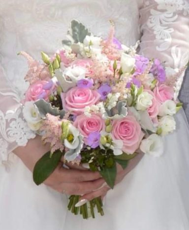 A bridal bouquet in pink and white, with Roses, Phlox, Eustoma, Lily of the Valley and foliage.
