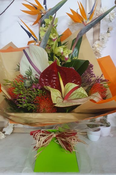 A vibrant bouquet featuring various tropical flowers and greenery.